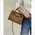 Coffee brown knotted intrecciato lambskin leather shoulder bag worn on shoulder