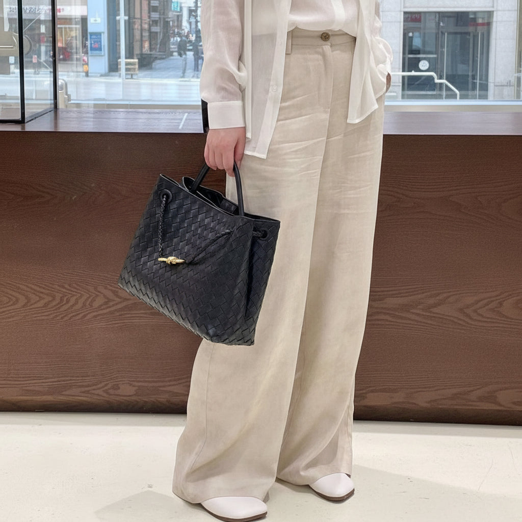 Full body lifestyle view showing the scale of the knotted intrecciato lambskin leather shoulder bag