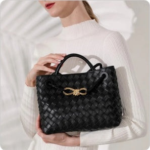 Black handwoven lambskin leather shoulder bag with knotted intrecciato weave and gold buckle